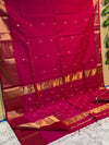 Crimson pink Maheshwari silk saree with a double design golden zari border and flower buti worked across the body and pallu.