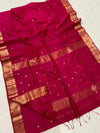 Crimson pink Maheshwari silk saree with a double design golden zari border and flower buti worked across the body and pallu.