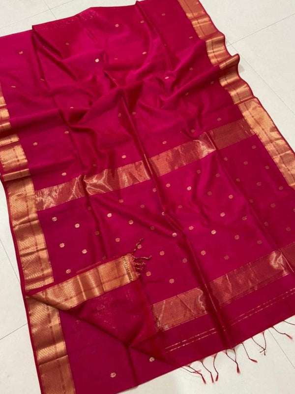 Crimson pink Maheshwari silk saree with a double design golden zari border and flower buti worked across the body and pallu.