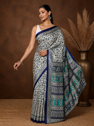 White Kashmiri Silk printed saree with an all-over small paisley print in dark blue and teal, a panelled dark-blue and teal pallu and a narrow dark-blue border.