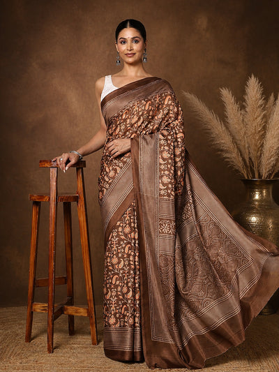 Brown printed saree in a floral paisley print with orange and green, a wide lattice border and a large medallion pallu.