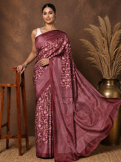 Maroon printed saree in a floral and paisley print with pink and green, edged by a broad, densely patterned border.