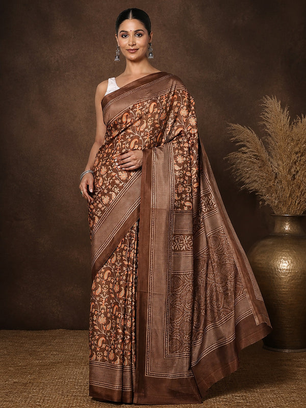 Brown Kashmiri Silk printed saree with a dense all-over floral and paisley print in orange and pale yellow, a geometric-lattice pallu and a repeating geometric-grid border.