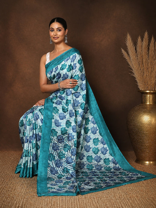 Tonal-blue Kashmiri Silk printed saree with a scattered leaf print in light and deep blue, an intricate scalloped end-panel, and a solid teal border.