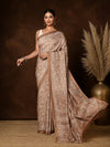 Light brown Kashmiri Silk printed saree with a dense all-over paisley and floral print, a wide banded pallu of florals and geometric lines and a narrow flat border.