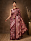 Deep maroon printed saree with panelled paisley clusters in gold and pink and a wide leaf-and-scroll border.