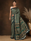 Forest green and gold geometric printed saree with chevron and diamond motifs and a striped end-panel, styled with a reference blouse.