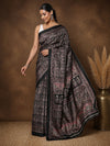 Black printed saree in a mauve and pink floral paisley print with a large floral medallion pallu and a narrow black border.