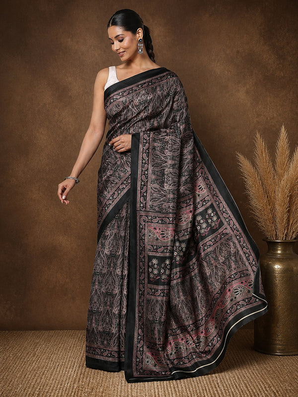 Black printed saree in a mauve and pink floral paisley print with a large floral medallion pallu and a narrow black border.