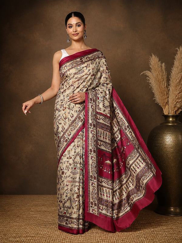 Beige printed Kashmiri silk saree with a magenta Warli-style figurative print of tribal figures and huts, a large magenta pallu panel of village scenes, and a narrow magenta border.