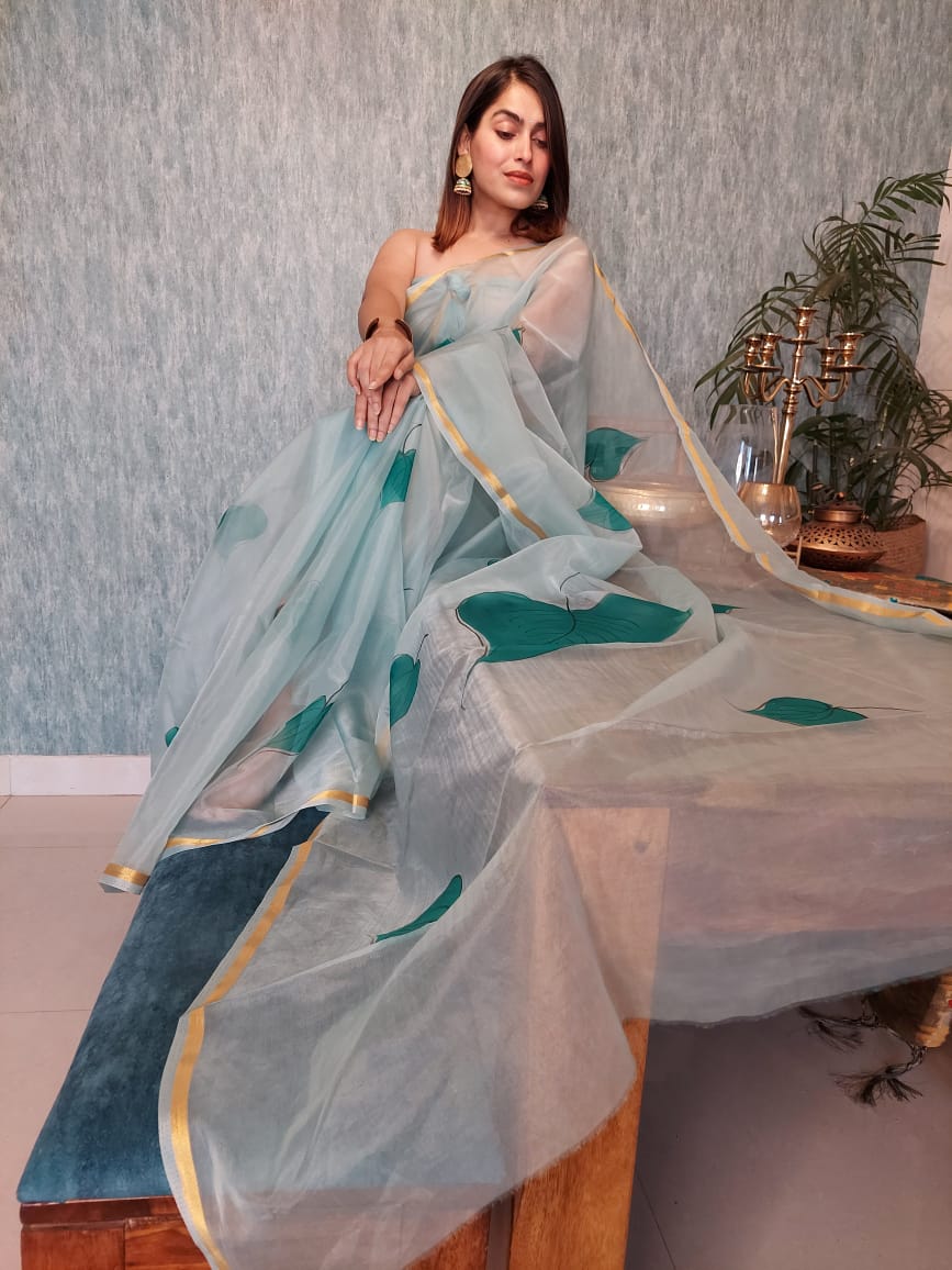 Hand Painted Organza Saree Light Green Colour with touch of gold print in vibrant Indian colours and matching running Blouse